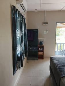 a living room with a bed and a couch at Mersing Chalet Teluk Sisek in Kampong Sisek +7 photos