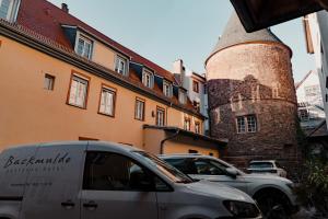a white van parked in front of a building at Hotel & Gasthaus Backmulde in Heidelberg