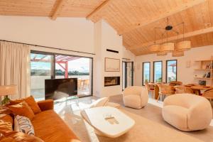 a living room with a couch and a table at SUNSET Keyweek Villa ocean view and private pool in Bidart