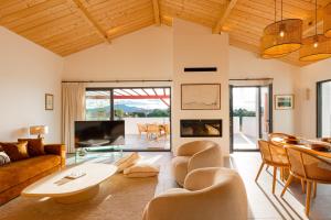 a living room with a couch and a table at SUNSET Keyweek Villa ocean view and private pool in Bidart