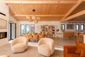 a living room with a table and chairs at SUNSET Keyweek Villa ocean view and private pool in Bidart +18 photos