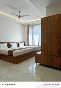 a bedroom with a large bed and a dresser at Hotel Pushkar Town in Pushkar