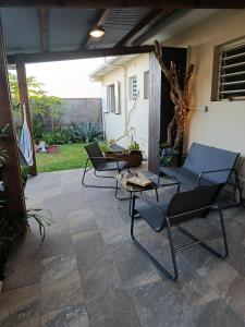 two chairs and a table on a patio at Ti ' Jean 4 étoiles in Saint-Joseph +59 photos