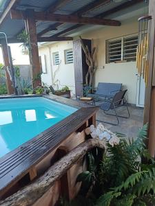 a pool in the backyard of a house at Ti ' Jean 4 étoiles in Saint-Joseph