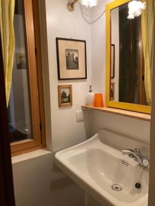 a bathroom with a sink and a mirror at Bed & Breakfast Villa Buzzati in Belluno +26 photos