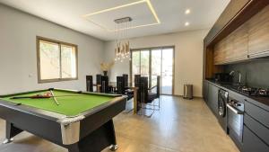 a room with a pool table in a kitchen at Beautiful Asma Villa with pool in Marrakesh