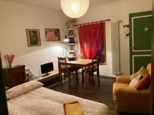 a living room with a table and a couch at Bed & Breakfast Villa Buzzati in Belluno
