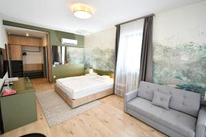 a bedroom with a bed and a couch at Angyal Villa in Rátka