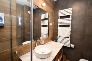a bathroom with a sink and a toilet and a mirror at Angyal Villa in Rátka +35 photos