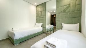 a bedroom with two beds and a mirror at Beautiful Asma Villa with pool in Marrakesh +31 photos