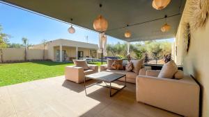 a living room with a couch and a table at Beautiful Asma Villa with pool in Marrakesh