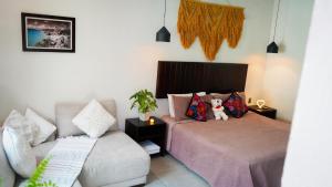 a bedroom with a bed and a couch at Hotel Diosa del Agua Bacalar in Bacalar +92 photos