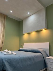a bedroom with a bed with two towels on it at La Concordia in Novi Ligure