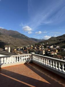 a white balcony with a view of a city at La Dimora in Morino