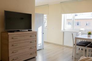 a living room with a flat screen tv on a dresser at Aia apartment in Valga