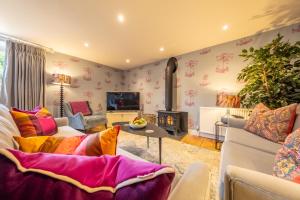 a living room with a couch and a fireplace at No33 WOODLANDS BOUTIQUE COTTAGE in Heacham