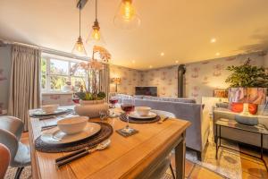 a dining room with a table with glasses of wine at No33 WOODLANDS BOUTIQUE COTTAGE in Heacham
