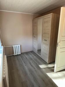 an empty room with a closet and a radiator at Aia apartment in Valga