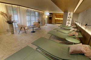 a waiting room with a row of green tables at Burghotel Schlaining in Stadtschlaining