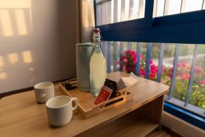a bottle of milk sitting on a table next to a window at Santonita Hotel & Tours in Ninh Hải