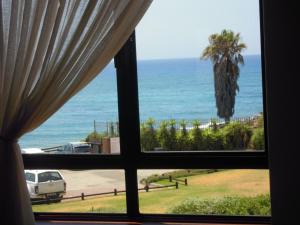 a view of the ocean from a window at King Fisher 6 in Mossel Bay