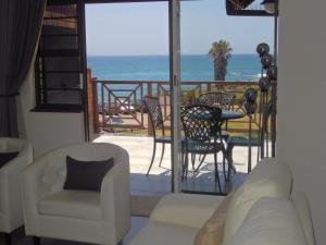 a living room with a view of the ocean at King Fisher 6 in Mossel Bay