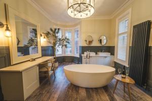 a large bathroom with a tub and a sink at The Fleece Hotel Richmond in Richmond +136 photos