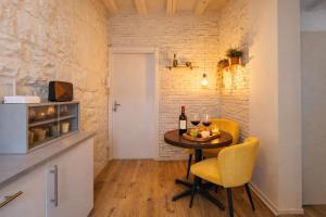 a small dining room with a table with wine glasses at Little Urban Home in Trieste