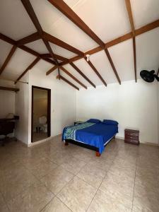 a bedroom with a blue bed in a room at Lago Calima Hostel in Calima