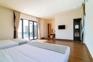 a hotel room with two beds and a television at Villa Layna's home in An Bàn (2) +74 photos