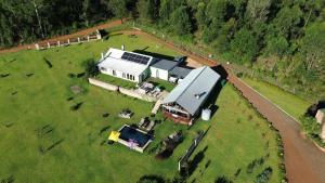 an aerial view of a large house with horses in a field at Round Here Self-Catering Holiday Home in Sabie