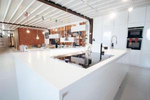 a kitchen with a white counter and a sink at Surf Sea and Sun in Biarritz +41 photos