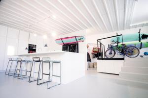 a kitchen with bar stools and a bike on the wall at Surf Sea and Sun in Biarritz