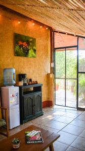 a kitchen with a refrigerator and a table in a room at Cabañas Sierra Gorda in Jalpan de Serra +29 photos