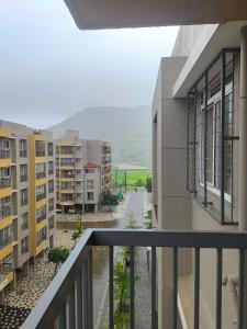 an apartment balcony with a view of a street at Apartment in Igatpuri! in Igatpuri