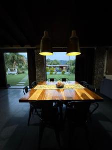 a wooden table in a room with a large window at Casa Ruta 1 in San José