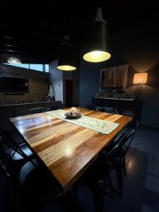 a wooden table with a plate of food on it at Casa Ruta 1 in San José