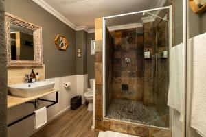 a bathroom with a shower and a sink at Kuilfontein Stable Cottages in Colesberg +77 photos