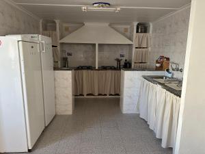a kitchen with a white refrigerator and a sink at La Marquesa - CA L'ONA in Poblenou del Delta
