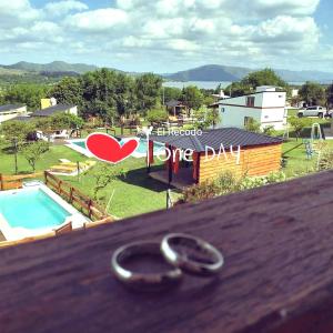 a pair of wedding rings sitting on top of a table at Cabañas el Recodo de Potrero in Potrero de Garay +8 photos