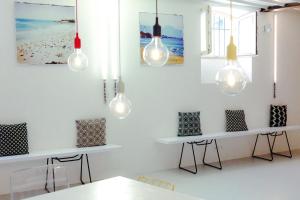 a room with two tables and lights on the wall at Surf Sea and Sun in Biarritz