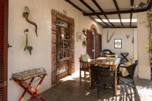 an outdoor patio with a table and chairs at Kuilfontein Stable Cottages in Colesberg
