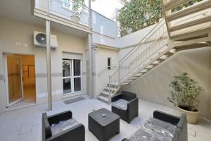 a building with a staircase and two chairs and a table at City Loft in Piacenza