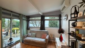 a living room with a chair and a window at La Colombe in Vienne
