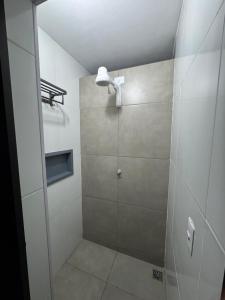 a shower with a glass door in a bathroom at Book a bed Jacumã in Conde