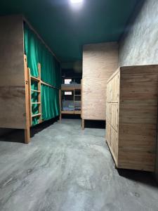 a room with two bunk beds and a green curtain at Book a bed Jacumã in Conde