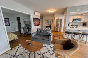 a living room and kitchen with a couch and a table at Serene in Seattle in Seattle