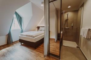 a bathroom with a shower and a bed in a room at Burghotel Schlaining in Stadtschlaining +43 photos