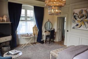 a living room with a table and a mirror at Ballyroe Lodge in Tralee