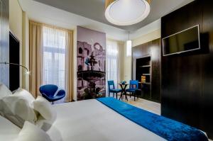 a hotel room with a large bed and a dining room at behotelisboa in Lisbon +52 photos